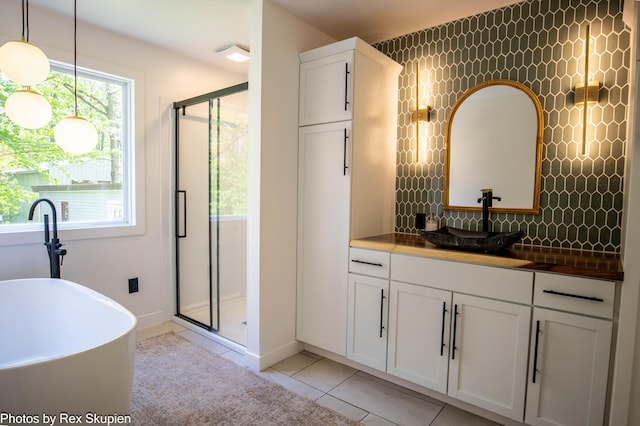 2490 S Parsons Ave, Fremont, MI 49412 - bathroom with a shower stall, tile patterned flooring, vanity, a freestanding bath, and tasteful backsplash