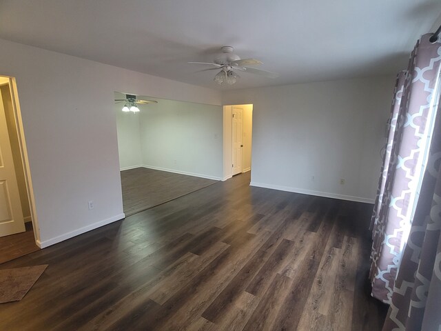 417 Prospect Unit # 210, Romeo, MI 48065 - unfurnished room featuring a ceiling fan, baseboards, and dark wood-type flooring