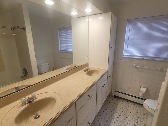 417 Prospect Unit # 210, Romeo, MI 48065 - full bathroom with baseboard heating, toilet, a shower, double vanity, and tile walls