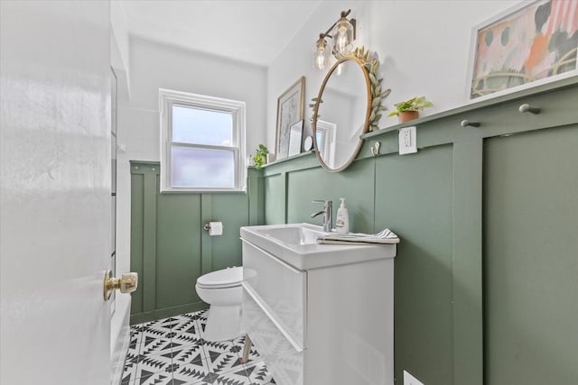 21111 Fleetwood Dr, Harper Woods, MI 48225 - bathroom with toilet, tile patterned floors, vanity, and a decorative wall