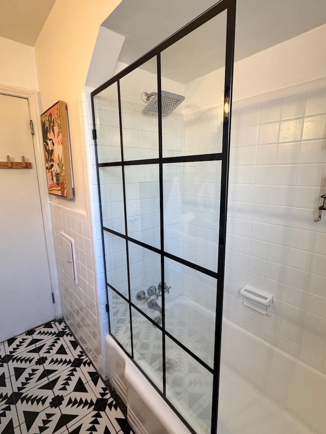 21111 Fleetwood Dr, Harper Woods, MI 48225 - full bath featuring tile patterned floors, bath / shower combo with glass door, tile walls, and wainscoting