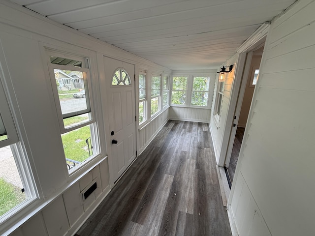 unfurnished sunroom with wood finished floors and plenty of natural light