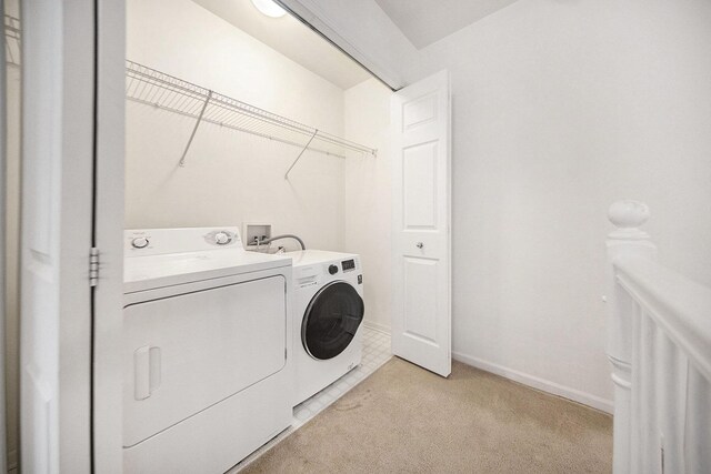 3197 Asher Rd, Ann Arbor, MI 48104 - washroom featuring washing machine and clothes dryer, light colored carpet, and baseboards