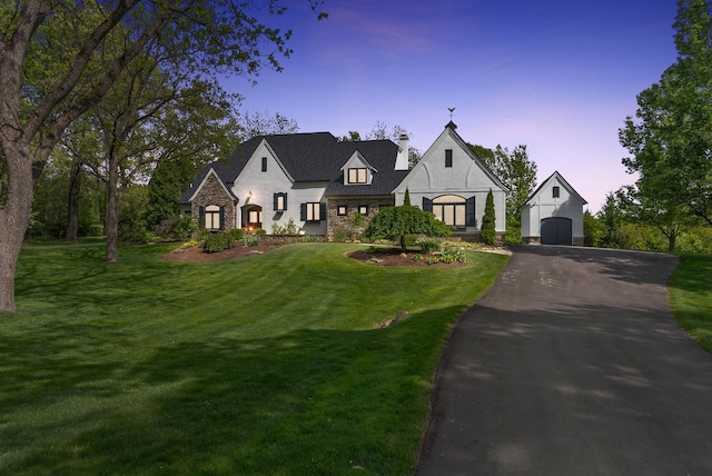 4263 Windmill Farms, Milford, MI 48380 - view of front facade with an outdoor structure, stone siding, a chimney, a front yard, and a detached garage