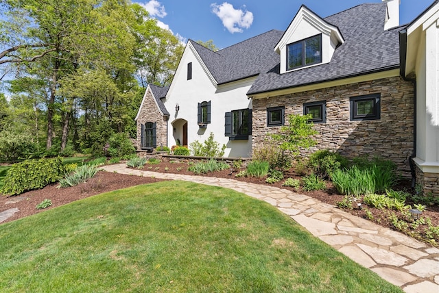 4263 Windmill Farms, Milford, MI 48380 - view of front of property featuring stone siding, stucco siding, a front yard, and roof with shingles