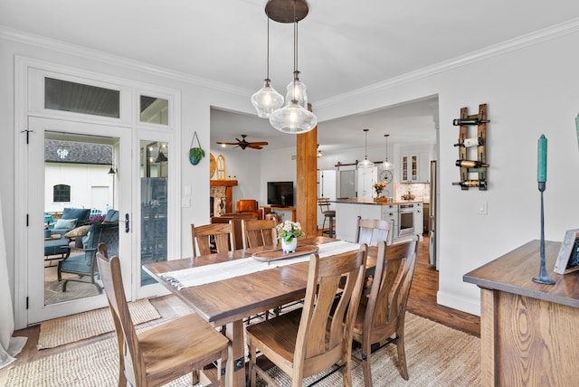 4263 Windmill Farms, Milford, MI 48380 - dining area featuring light wood-style floors, ornamental molding, a ceiling fan, and baseboards
