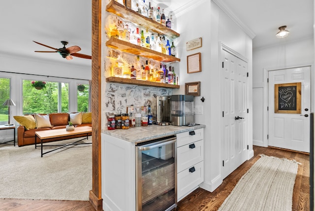 4263 Windmill Farms, Milford, MI 48380 - indoor dry bar with beverage cooler, ornamental molding, a ceiling fan, and dark wood-type flooring