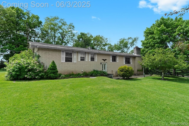 7109 Lake Shore Dr, Chelsea, MI 48118 - view of front of house with brick siding, a front lawn, and a chimney