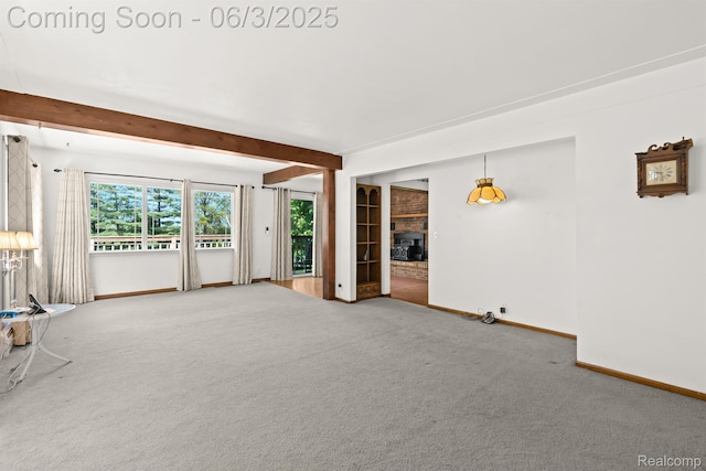 7109 Lake Shore Dr, Chelsea, MI 48118 - unfurnished living room featuring baseboards, carpet, a brick fireplace, and beam ceiling