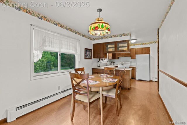 7109 Lake Shore Dr, Chelsea, MI 48118 - dining room featuring baseboard heating and light wood-type flooring