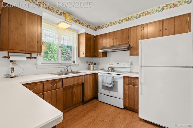 7109 Lake Shore Dr, Chelsea, MI 48118 - kitchen featuring white appliances, a sink, under cabinet range hood, and brown cabinets