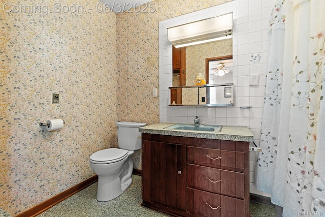 7109 Lake Shore Dr, Chelsea, MI 48118 - bathroom with toilet, vanity, tile walls, and baseboards
