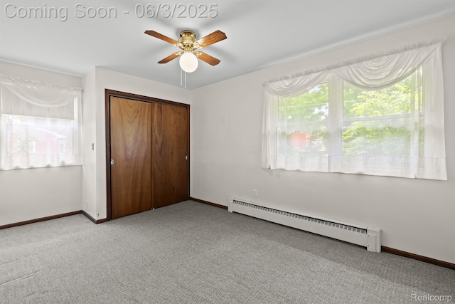 7109 Lake Shore Dr, Chelsea, MI 48118 - unfurnished bedroom with a baseboard radiator, light carpet, baseboards, and a closet