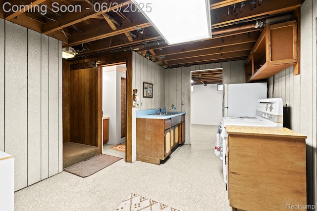 7109 Lake Shore Dr, Chelsea, MI 48118 - finished basement featuring freestanding refrigerator, wood walls, and a sink