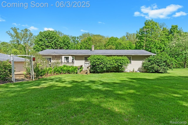 7109 Lake Shore Dr, Chelsea, MI 48118 - view of front of property with a front yard and a deck