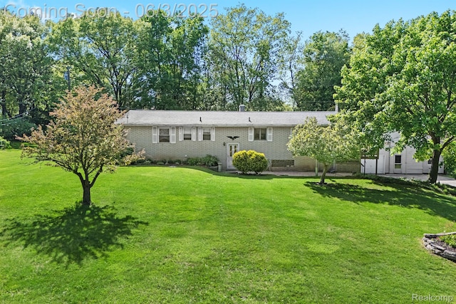 7109 Lake Shore Dr, Chelsea, MI 48118 - rear view of house with a lawn and brick siding