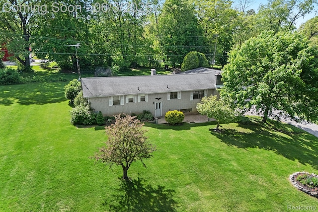 7109 Lake Shore Dr, Chelsea, MI 48118 - view of front of house featuring a patio and a front lawn