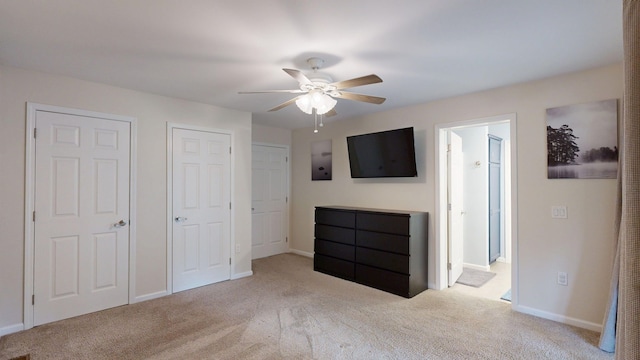 1670 Edwin Dr, Brighton, MI 48114 - unfurnished bedroom featuring carpet, baseboards, ensuite bath, a ceiling fan, and multiple closets