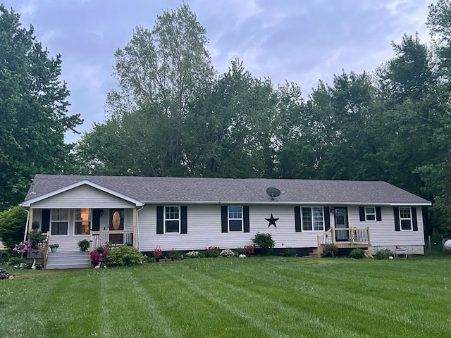 4557 Gannon Rd, Fowlerville, MI 48836 - view of front of home with a front yard, a shingled roof, and covered porch