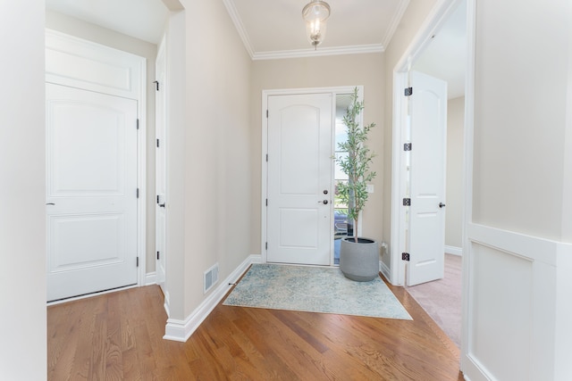 10408 Stoney Point Dr, South Lyon, MI 48178 - entryway with wood finished floors, baseboards, and crown molding
