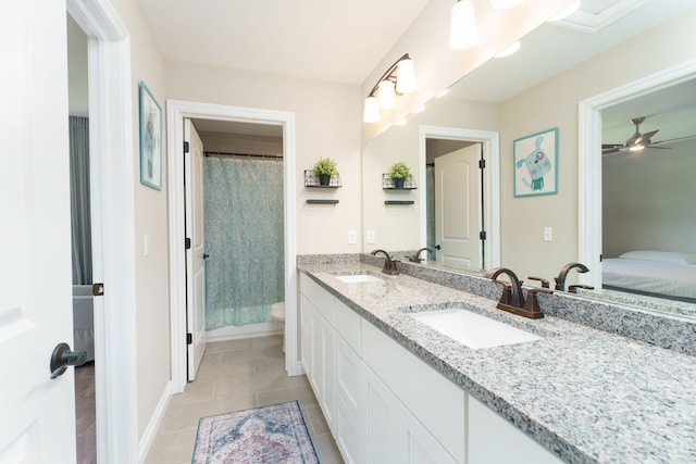 10408 Stoney Point Dr, South Lyon, MI 48178 - ensuite bathroom featuring toilet, tile patterned floors, double vanity, ceiling fan, and baseboards