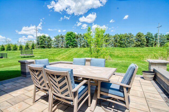 10408 Stoney Point Dr, South Lyon, MI 48178 - view of patio / terrace with a trampoline and outdoor dining space