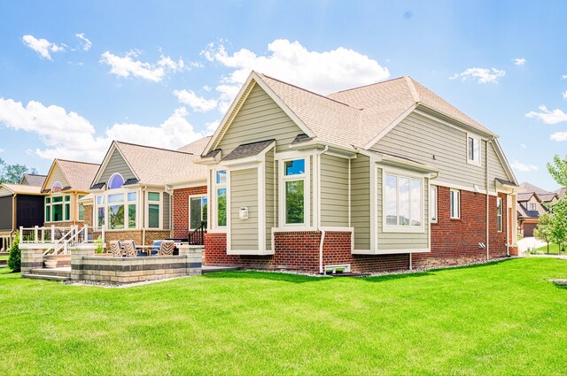 10408 Stoney Point Dr, South Lyon, MI 48178 - rear view of house with a lawn and brick siding