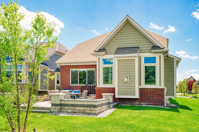 10408 Stoney Point Dr, South Lyon, MI 48178 - back of property with a patio area, brick siding, a lawn, and roof with shingles