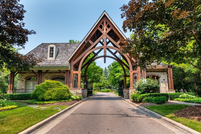 10408 Stoney Point Dr, South Lyon, MI 48178 - view of asphalt road with curbs and a gated entry