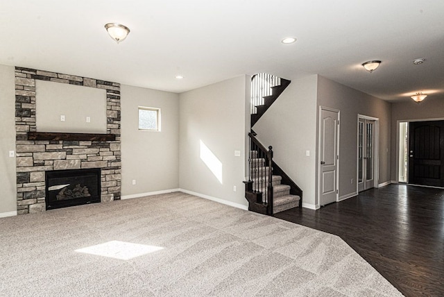 53209 Woodland Mdws, Clinton Township, MI 48047 - unfurnished living room with stairway, baseboards, a fireplace, wood finished floors, and recessed lighting