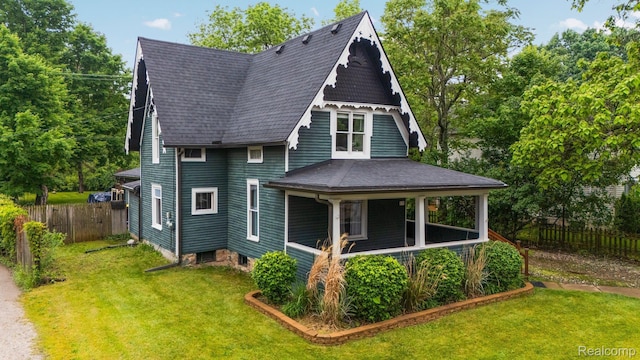 330 W Main St, Pinckney, MI 48169 - view of front of home with a shingled roof and covered porch