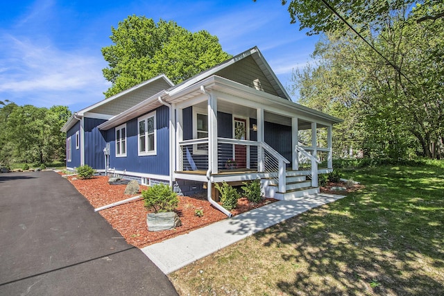 3401 Hicks Ave, Benton Harbor, MI 49022 - view of front of home featuring a porch, a front yard, and asphalt driveway