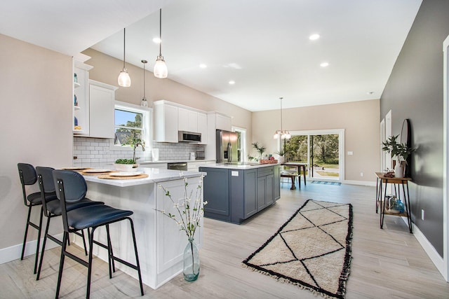 3401 Hicks Ave, Benton Harbor, MI 49022 - kitchen featuring appliances with stainless steel finishes, baseboards, tasteful backsplash, light countertops, and healthy amount of natural light