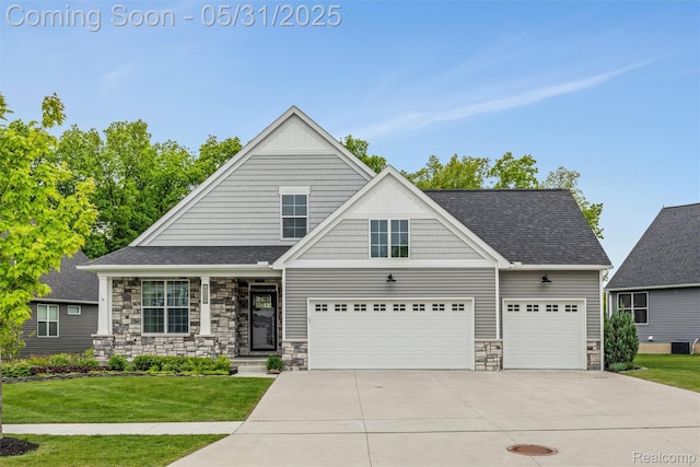 4280 Rolling Meadow Ln, Ypsilanti, MI 48197 - view of front of house with stone siding, driveway, and a front yard