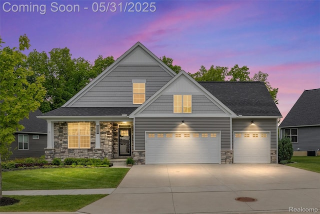 4280 Rolling Meadow Ln, Ypsilanti, MI 48197 - view of front facade featuring stone siding, concrete driveway, a front yard, and a garage
