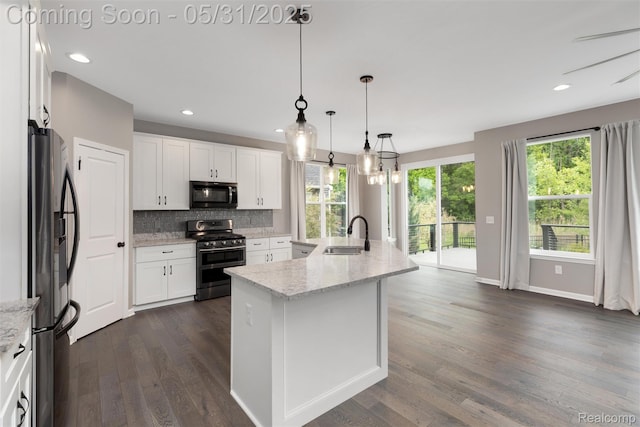4280 Rolling Meadow Ln, Ypsilanti, MI 48197 - kitchen featuring stainless steel appliances, a sink, backsplash, dark wood-style flooring, and white cabinets