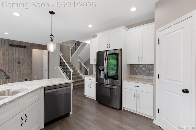 4280 Rolling Meadow Ln, Ypsilanti, MI 48197 - kitchen featuring appliances with stainless steel finishes, a sink, white cabinetry, backsplash, and decorative light fixtures