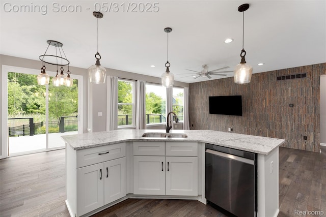 4280 Rolling Meadow Ln, Ypsilanti, MI 48197 - kitchen featuring dishwasher, a sink, a ceiling fan, healthy amount of natural light, and wooden walls