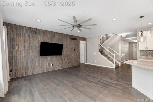 4280 Rolling Meadow Ln, Ypsilanti, MI 48197 - unfurnished living room featuring an accent wall, stairs, a ceiling fan, recessed lighting, and wood finished floors