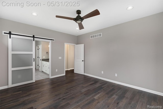4280 Rolling Meadow Ln, Ypsilanti, MI 48197 - unfurnished bedroom featuring a barn door, dark wood-style floors, baseboards, recessed lighting, and ensuite bathroom