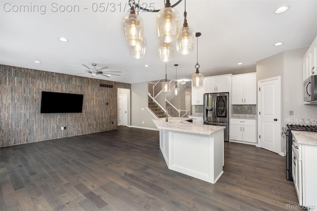 4280 Rolling Meadow Ln, Ypsilanti, MI 48197 - kitchen featuring an accent wall, appliances with stainless steel finishes, open floor plan, recessed lighting, and a ceiling fan