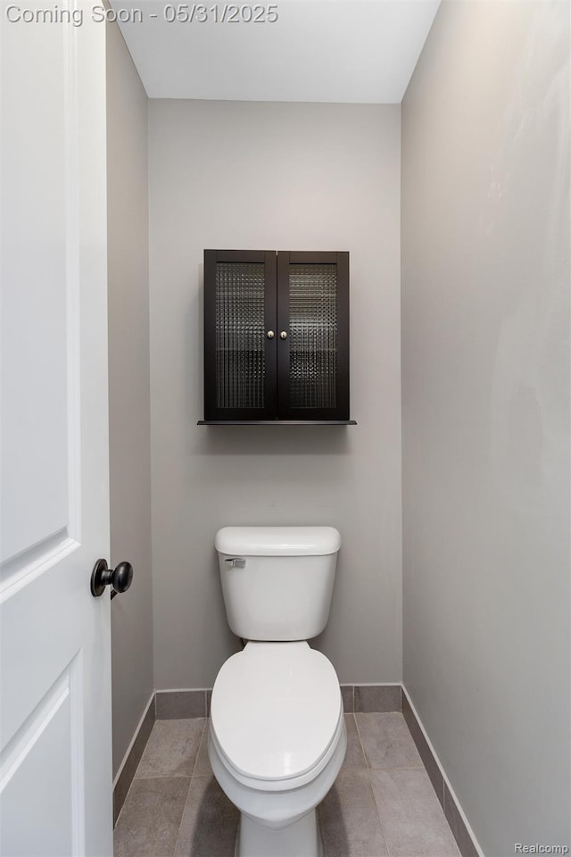 4280 Rolling Meadow Ln, Ypsilanti, MI 48197 - bathroom with baseboards, toilet, and tile patterned floors