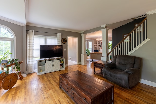 5100 Perry Rd, Grand Blanc, MI 48439 - living room with decorative columns, light wood-style flooring, ornamental molding, baseboards, and stairway