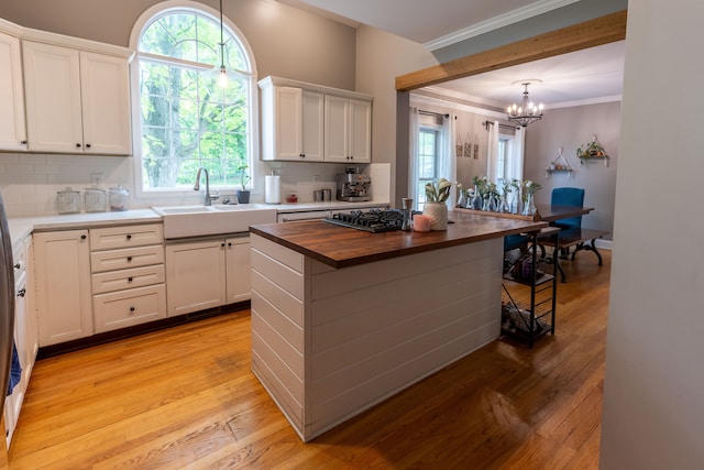 5100 Perry Rd, Grand Blanc, MI 48439 - kitchen with wood counters, a sink, tasteful backsplash, a chandelier, and light wood finished floors