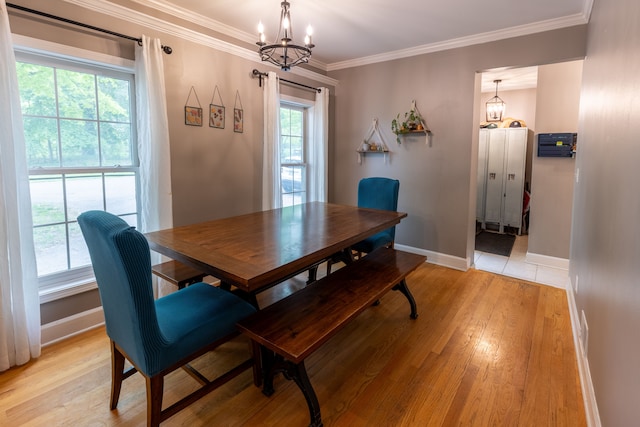 5100 Perry Rd, Grand Blanc, MI 48439 - dining area featuring a chandelier, light wood finished floors, baseboards, and crown molding