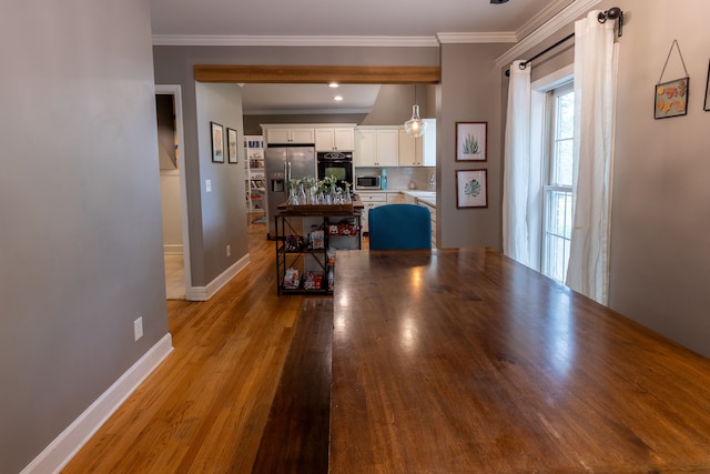 5100 Perry Rd, Grand Blanc, MI 48439 - kitchen featuring stainless steel appliances, white cabinets, baseboards, crown molding, and wood finished floors