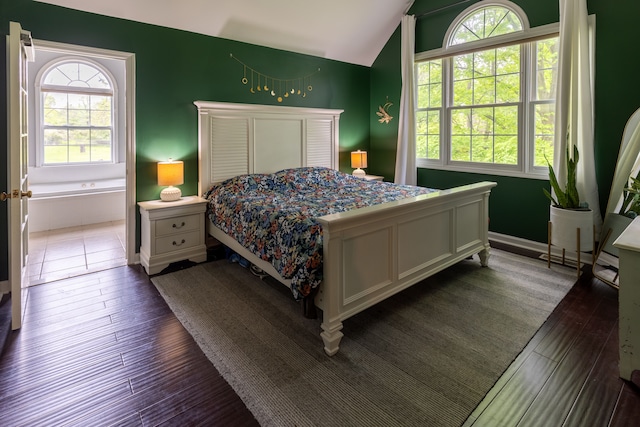 5100 Perry Rd, Grand Blanc, MI 48439 - bedroom with vaulted ceiling, multiple windows, and dark wood-type flooring