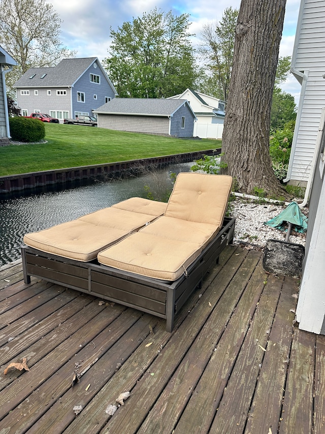 11181 W Ferndale Dr, Manitou Beach, MI 49253 - deck featuring a covered hot tub, a lawn, and a water view