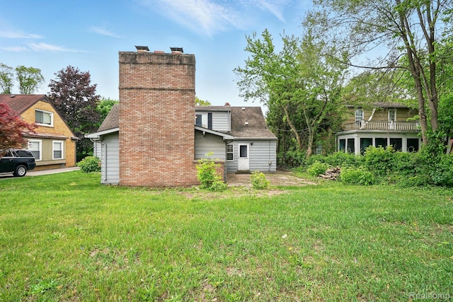 2332 Nolen Dr, Flint, MI 48504 - back of property with a chimney and a lawn