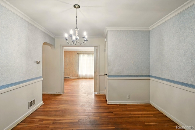2332 Nolen Dr, Flint, MI 48504 - unfurnished dining area featuring ornamental molding, wood finished floors, a chandelier, arched walkways, and baseboards